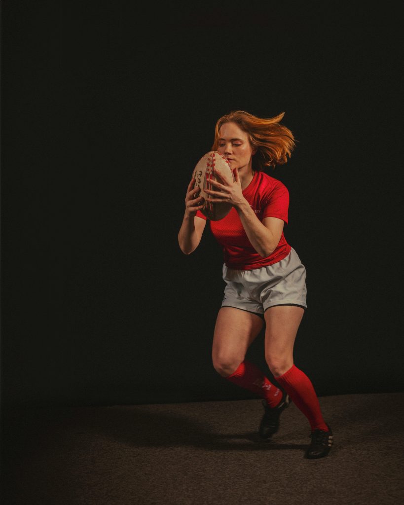 zipwp-image-30125703 Studio portrait of a female athlete playing rugby, capturing energy and focus.